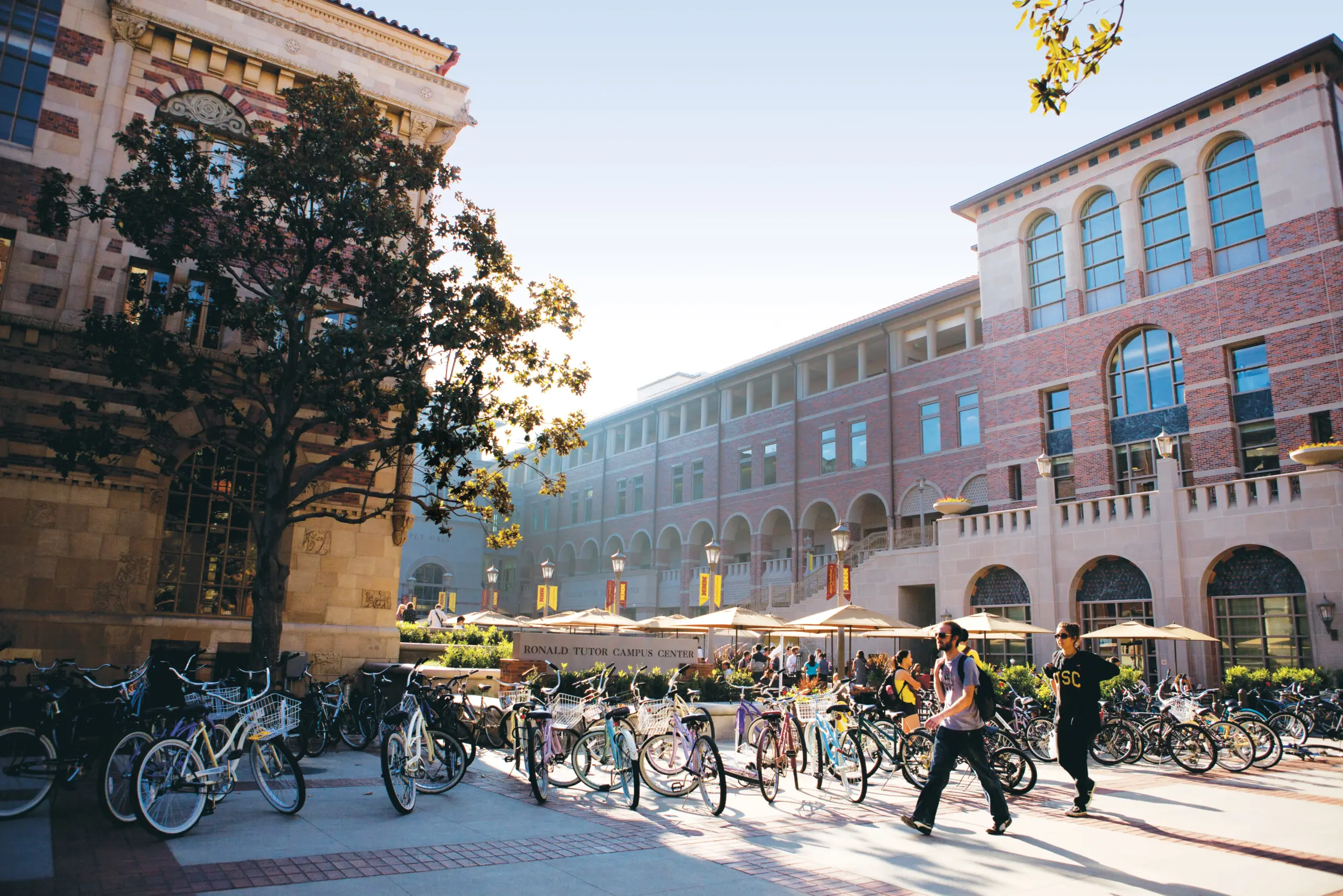 Students walking across Ronald Tutor Center after grabbing their lunch on a sunny day.