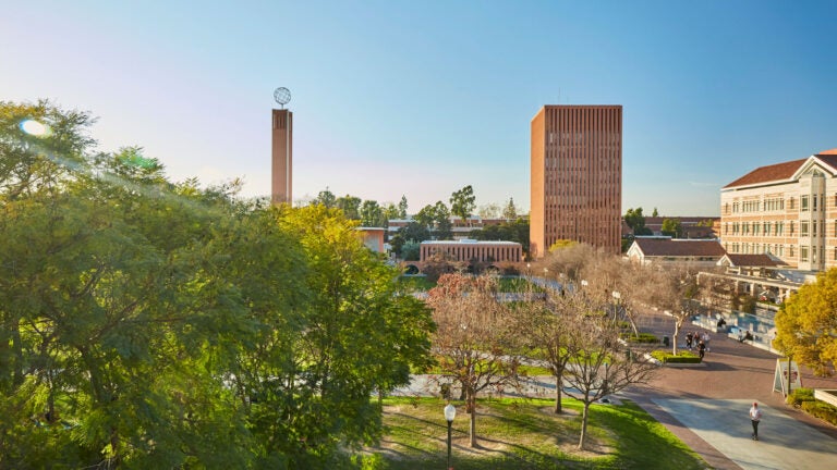 McCarthy Quad with a wide shot of Dr. Joseph Medicine Crow Center for International and Public Affairs and Leavey Library as the sun sets on campus.