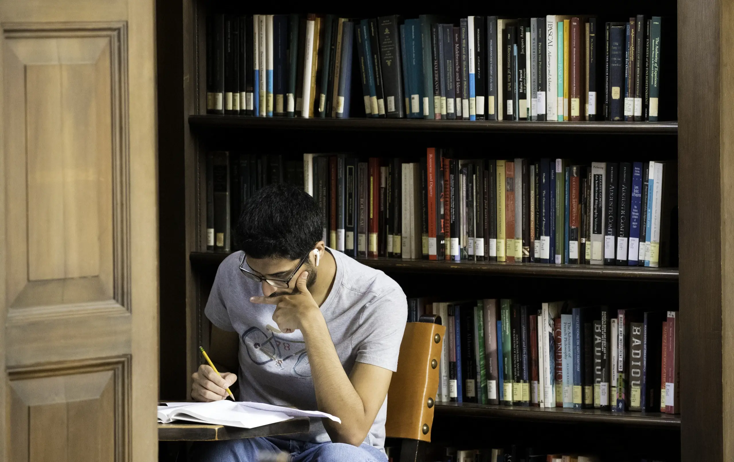 USC graduate student studying in a library